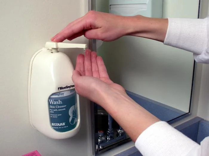 Application de savon sur des mains mouillées, photographie pédagogique de laboratoire, 2004.